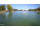 The pond is a serene water feature complemented by fountains and lush green landscaping at 44125 W Cydnee Dr, Maricopa, AZ 85138