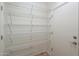A storage room with wire shelving and a closed door at 44125 W Cydnee Dr, Maricopa, AZ 85138