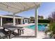 Spacious backyard with a pool, covered patio, pergola, and outdoor dining area, perfect for entertaining at 4639 E Mulberry Dr, Phoenix, AZ 85018