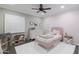 This bedroom features a decorative accent wall, shutters, and a ceiling fan at 4639 E Mulberry Dr, Phoenix, AZ 85018
