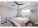 This bedroom has a ceiling fan and a large window at 4639 E Mulberry Dr, Phoenix, AZ 85018
