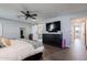 A large tv and barn door leading to the bathroom are some of the features of this main bedroom at 4639 E Mulberry Dr, Phoenix, AZ 85018