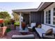 Relaxing outdoor patio with comfortable seating, brick columns, and ambient string lights at 4639 E Mulberry Dr, Phoenix, AZ 85018