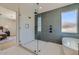 This glass shower features sleek fixtures, gray vertical tile, and a built-in niche at 4640 E Glenrosa Ave, Phoenix, AZ 85018