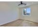 Bright bedroom featuring hardwood floors, a modern ceiling fan, and a large window with neighborhood views at 4640 E Glenrosa Ave, Phoenix, AZ 85018