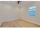 Bright empty bedroom with hardwood floors and a view of the yard from the window at 4640 E Glenrosa Ave, Phoenix, AZ 85018