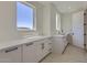 Well-lit laundry room featuring white shaker cabinetry, modern fixtures, ample counter space, and a decorative tiled floor at 4640 E Glenrosa Ave, Phoenix, AZ 85018