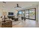 Inviting living room featuring hardwood floors, a ceiling fan, and expansive windows for seamless indoor-outdoor living at 4640 E Glenrosa Ave, Phoenix, AZ 85018