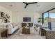 Bright living room with a modern ceiling fan, stylish decor, and large windows for abundant natural light at 4640 E Glenrosa Ave, Phoenix, AZ 85018