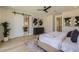 Main bedroom with hardwood floors and barn door entry to bath offers comfort and style at 4640 E Glenrosa Ave, Phoenix, AZ 85018