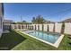 Inviting swimming pool in a backyard with artificial turf, a wall, and privacy landscaping at 4640 E Glenrosa Ave, Phoenix, AZ 85018