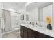 Modern bathroom featuring a double vanity with dark cabinets and a shower-tub combination at 5046 W Karl St, San Tan Valley, AZ 85144