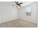 Neutral bedroom with a ceiling fan, carpet floors, and a window with blinds at 5046 W Karl St, San Tan Valley, AZ 85144