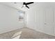 Bright bedroom with a ceiling fan, carpet flooring, and a closet at 5046 W Karl St, San Tan Valley, AZ 85144