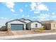 The home features a two-car garage, low-maintenance landscaping, and a brick driveway at 5046 W Karl St, San Tan Valley, AZ 85144