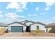 Charming single-story home featuring a well-manicured front yard and a two-car garage at 5046 W Karl St, San Tan Valley, AZ 85144
