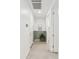 A hallway with white walls, tile floors, and decorative wainscoting at 5046 W Karl St, San Tan Valley, AZ 85144