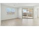 Bright living area with tiled floors, large windows, and a sliding glass door to the backyard at 5046 W Karl St, San Tan Valley, AZ 85144