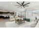 Open-concept living room with stylish furniture, a modern ceiling fan, and a view of the kitchen at 5046 W Karl St, San Tan Valley, AZ 85144