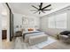 A staged main bedroom includes a large bed, carpet floors, a ceiling fan, and a decorative barn door at 5046 W Karl St, San Tan Valley, AZ 85144