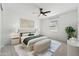 Spacious main bedroom with a ceiling fan, neutral colors, and an en-suite bath at 5046 W Karl St, San Tan Valley, AZ 85144