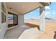 The covered patio of a residence offers a shaded area overlooking the backyard at 5046 W Karl St, San Tan Valley, AZ 85144