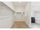 Spacious walk-in closet with carpet flooring and built in shelving at 5046 W Karl St, San Tan Valley, AZ 85144