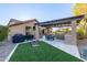 Backyard with artificial turf, outdoor kitchen, built-in barbecue, and desert landscaping at 5215 S Monte Vista St, Chandler, AZ 85249