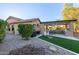 Backyard with artificial turf, outdoor kitchen, built-in barbecue, and desert landscaping at 5215 S Monte Vista St, Chandler, AZ 85249