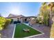 Backyard featuring outdoor kitchen with a built-in grill and artificial turf for recreational use at 5215 S Monte Vista St, Chandler, AZ 85249