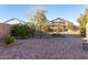 Spacious backyard with mature trees, gravel landscaping, and a gardening trellis at 5215 S Monte Vista St, Chandler, AZ 85249
