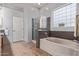 Bright bathroom features a tub, a walk-in shower, a frosted glass window and ceramic tile floors at 5215 S Monte Vista St, Chandler, AZ 85249