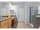 Well-lit bathroom features dual sinks, wood cabinets, tile flooring and a walk-in shower at 5215 S Monte Vista St, Chandler, AZ 85249