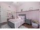 Inviting pink bedroom with a gray bed, soft lighting, and organized décor at 5215 S Monte Vista St, Chandler, AZ 85249