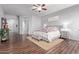 Light-filled main bedroom with wood floors, neutral walls and a gray upholstered bed with seating at 5215 S Monte Vista St, Chandler, AZ 85249