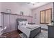 Pink bedroom with a gray upholstered bed, a modern rug, and ample natural light at 5215 S Monte Vista St, Chandler, AZ 85249