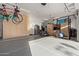 Bright garage featuring epoxy flooring, storage cabinets, and a workout space at 5215 S Monte Vista St, Chandler, AZ 85249