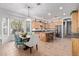 Open kitchen featuring wood cabinets, stainless steel appliances, an island, and adjacent dining area at 5215 S Monte Vista St, Chandler, AZ 85249