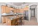 Kitchen island featuring wood cabinets, granite countertops, seating, and stainless steel appliances at 5215 S Monte Vista St, Chandler, AZ 85249