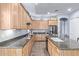 Bright kitchen with wood cabinets, granite countertops, an island and stainless steel appliances at 5215 S Monte Vista St, Chandler, AZ 85249