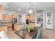 Eat-in kitchen with wood cabinets, stainless steel appliances, and an island with seating perfect for entertaining at 5215 S Monte Vista St, Chandler, AZ 85249