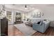 Spacious living room with a fireplace, hardwood floors, large windows, and a comfortable sectional sofa at 5215 S Monte Vista St, Chandler, AZ 85249