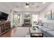 Bright living room featuring hardwood floors, a fireplace, large windows, and comfortable sectional sofa at 5215 S Monte Vista St, Chandler, AZ 85249