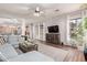 Open concept living room featuring hardwood floors, large windows, and a comfortable sectional sofa at 5215 S Monte Vista St, Chandler, AZ 85249