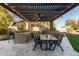 Covered outdoor kitchen and dining area for entertaining, complete with a built-in grill at 5215 S Monte Vista St, Chandler, AZ 85249