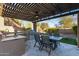 Covered outdoor kitchen and dining area for entertaining, complete with a built-in grill at 5215 S Monte Vista St, Chandler, AZ 85249