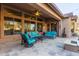 Inviting covered patio with stylish seating, a ceiling fan, and a cozy fireplace at 5215 S Monte Vista St, Chandler, AZ 85249