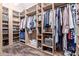 Organized walk-in closet with custom shelves, hanging rods, and ample storage space at 5215 S Monte Vista St, Chandler, AZ 85249