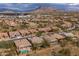 Scenic aerial view of a neighborhood, showcasing homes with pools and stunning mountain backdrops at 5723 E Jake Hvn, Cave Creek, AZ 85331