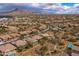 Expansive aerial view of a desert community with many single Gathering homes nestled near the mountains at 5723 E Jake Hvn, Cave Creek, AZ 85331